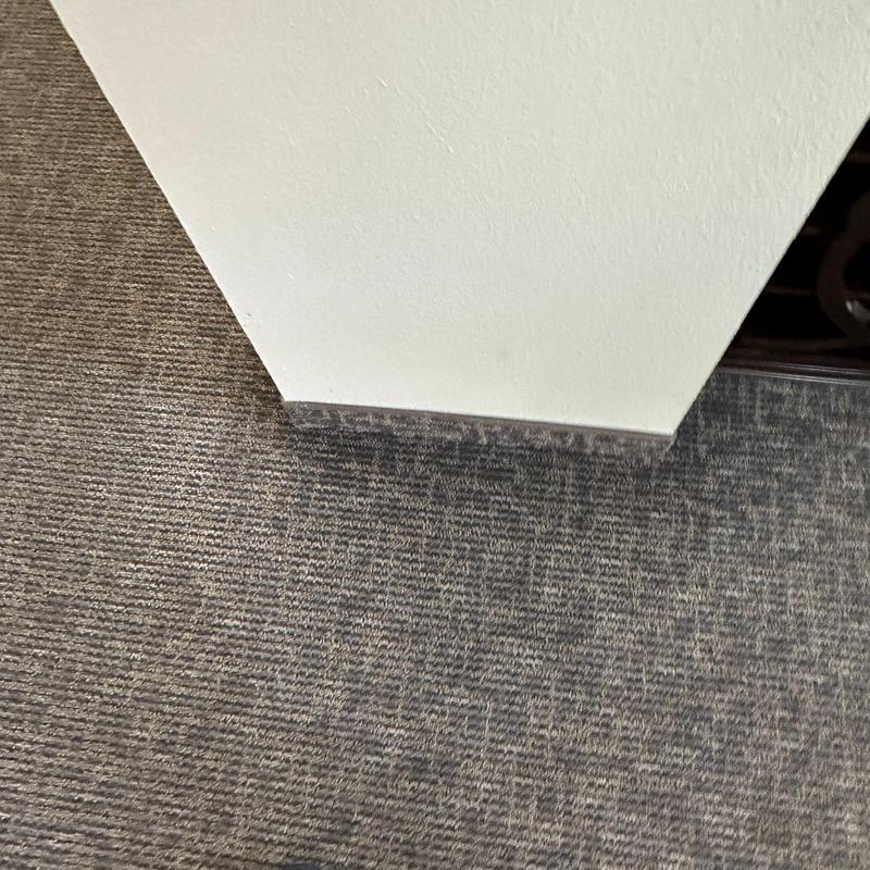 Carpet flooring near baseboard corner inside building Carpet flooring near baseboard corner inside building