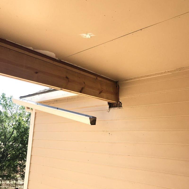 Exterior wall and soffit beam damage at building corner Exterior wall and soffit beam damage at building corner