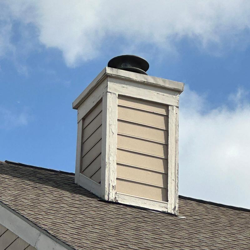 Chimney exterior siding and trim on roof peak Chimney exterior siding and trim on roof peak
