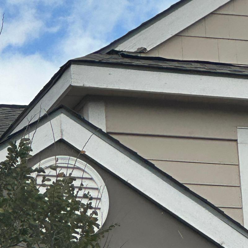 Roof edge and siding damage on residential building Roof edge and siding damage on residential building