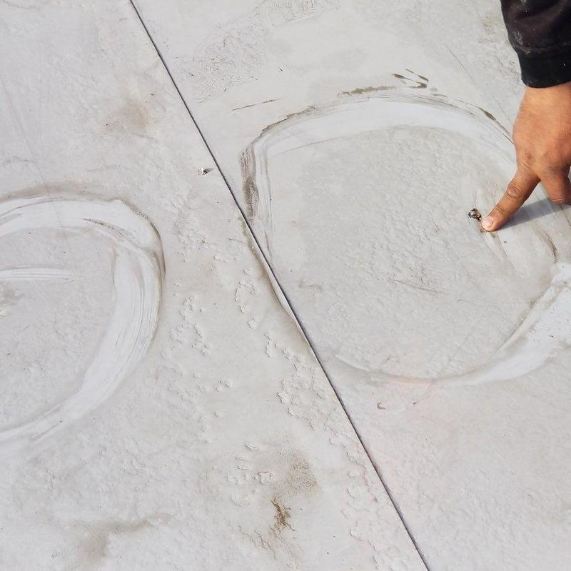 Concrete roof surface with damage and finger pointing Concrete roof surface with damage and finger pointing