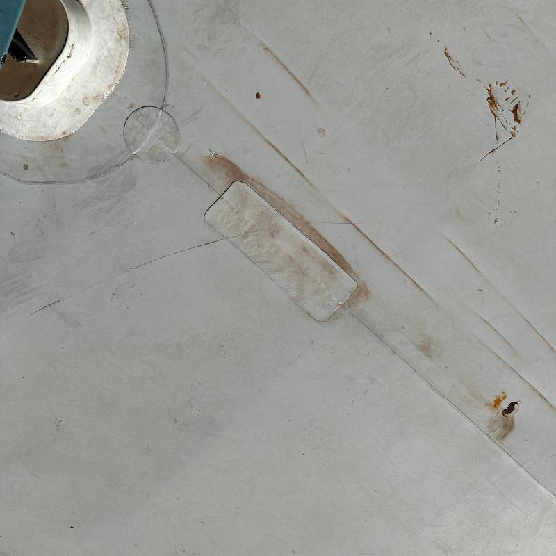Concrete roof patch and metal drain flange on gray surface Concrete roof patch and metal drain flange on gray surface
