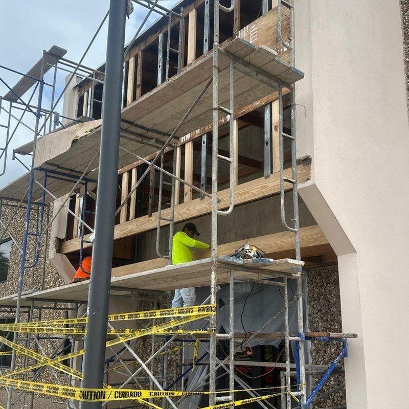 Concrete wall damage restoration with scaffolding Concrete wall damage restoration with scaffolding