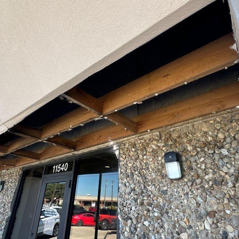 Exposed wooden ceiling beams above commercial entry Exposed wooden ceiling beams above commercial entry