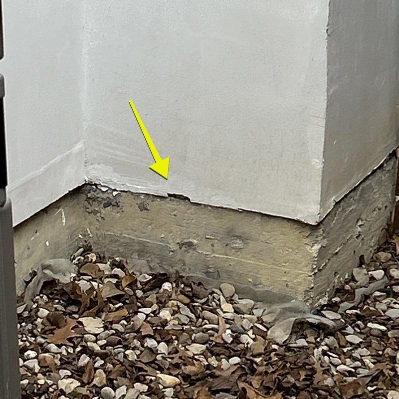 Stucco wall corner with cracked base trim Stucco wall corner with cracked base trim