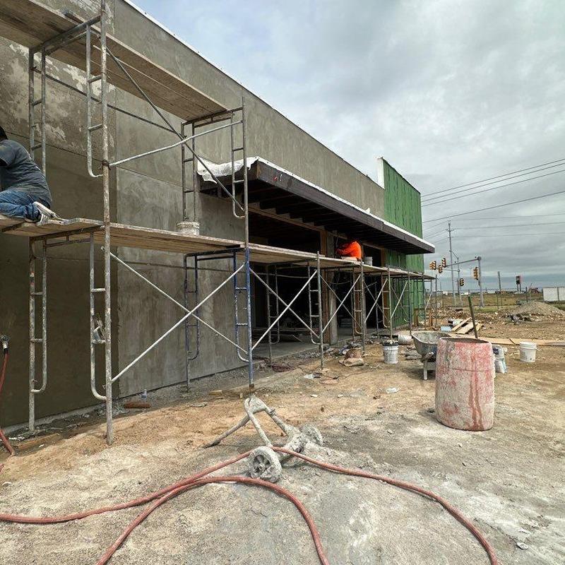 Concrete exterior wall with scaffolding at cafe site Concrete exterior wall with scaffolding at cafe site