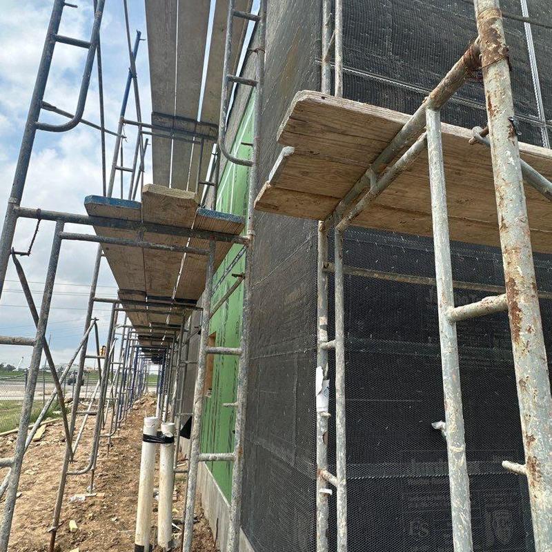 Concrete wall scaffolding setup at cafe construction site Concrete wall scaffolding setup at cafe construction site