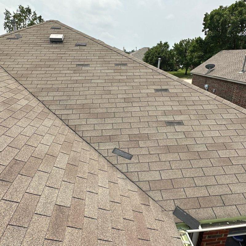 Roof shingles with storm damage on residential home Roof shingles with storm damage on residential home