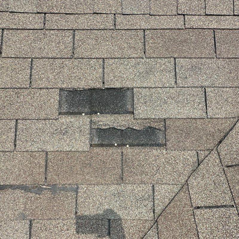 Asphalt roof shingles with hail damage and repairs Asphalt roof shingles with hail damage and repairs