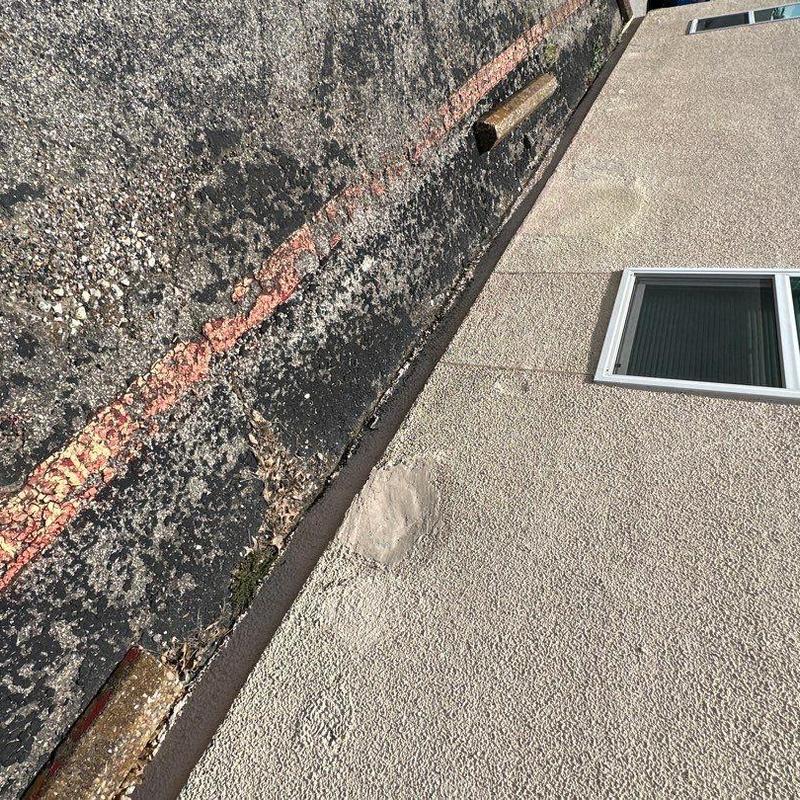 Concrete wall with stucco patches near window Concrete wall with stucco patches near window