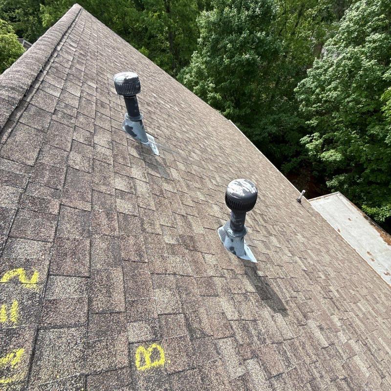 Roof shingles inspection with marked hail damage areas