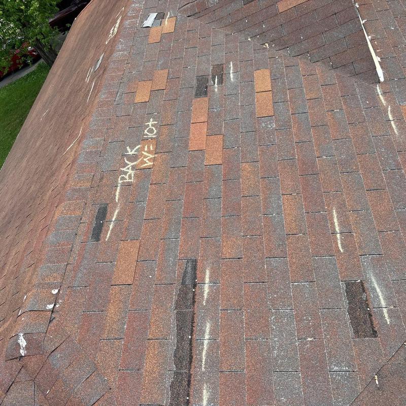 Asphalt shingle roof with hail impact markings