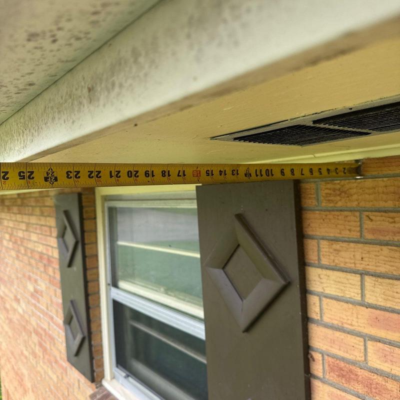 Eave soffit with ventilation grille and measuring tape
