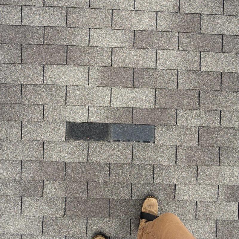 Asphalt roof shingles with visible damage and wear