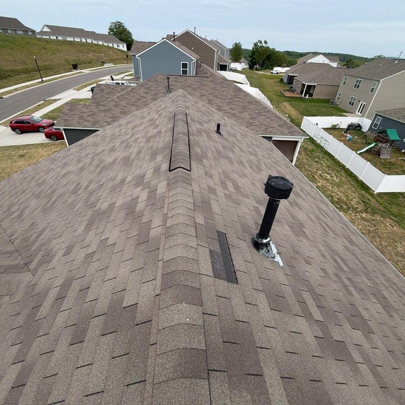 Asphalt shingle roof with vent pipe and ridge cap
