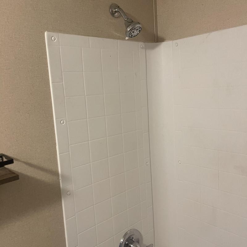 Showerhead and tub wall panels installation in bathroom Showerhead and tub wall panels installation in bathroom
