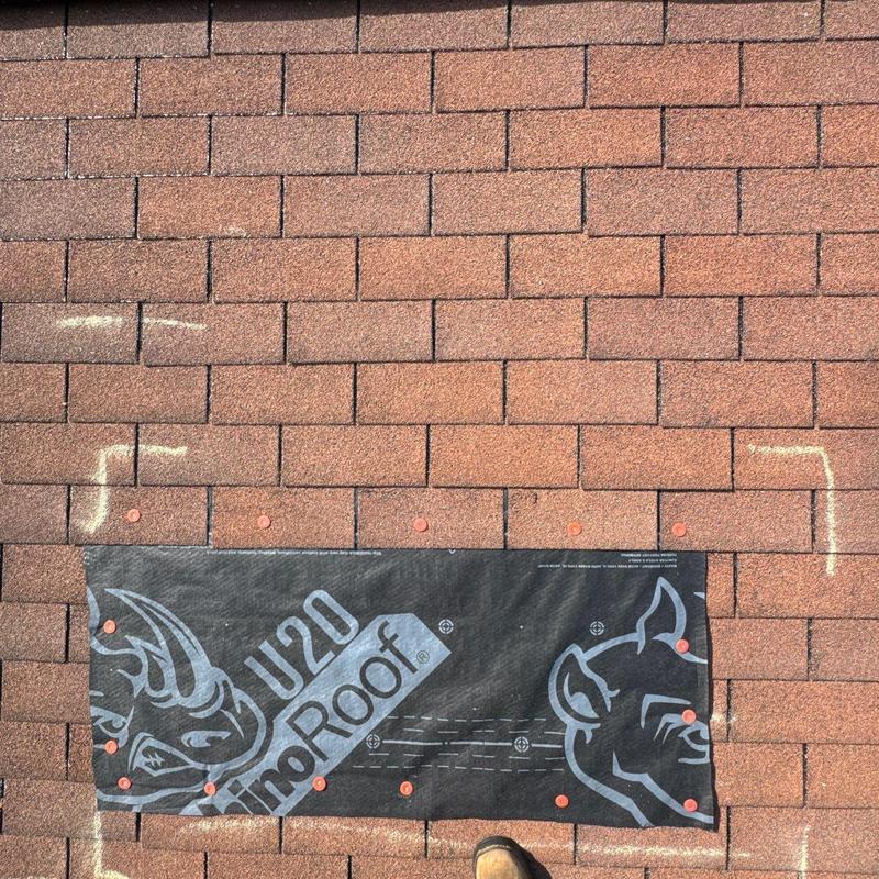 Asphalt shingles with storm damage marked for repair