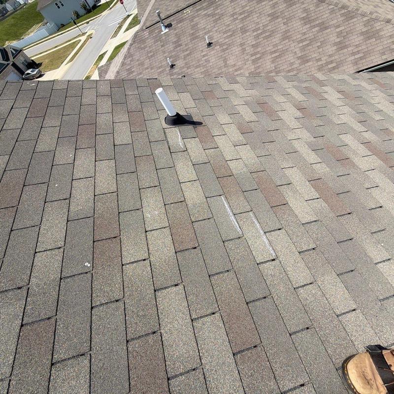 Roof shingles with hail damage marks and vents