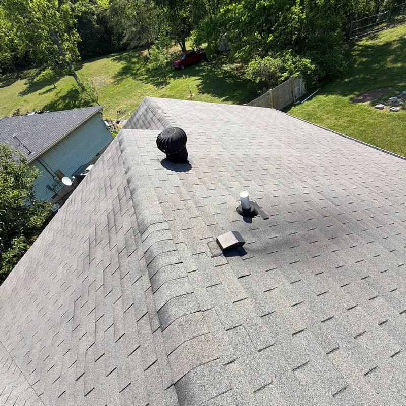 Asphalt shingle roof with ventilation pipes and turbine vent
