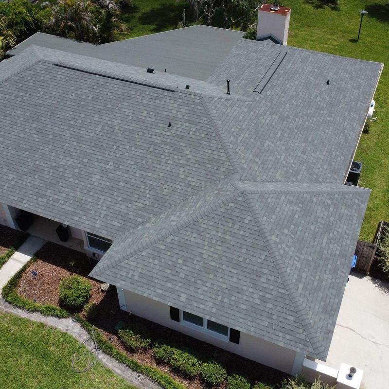 Gray shingle roof with multiple hips and vents Gray shingle roof with multiple hips and vents