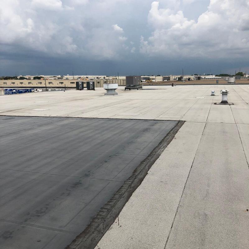 Concrete and metal roofing patches on commercial roof Concrete and metal roofing patches on commercial roof