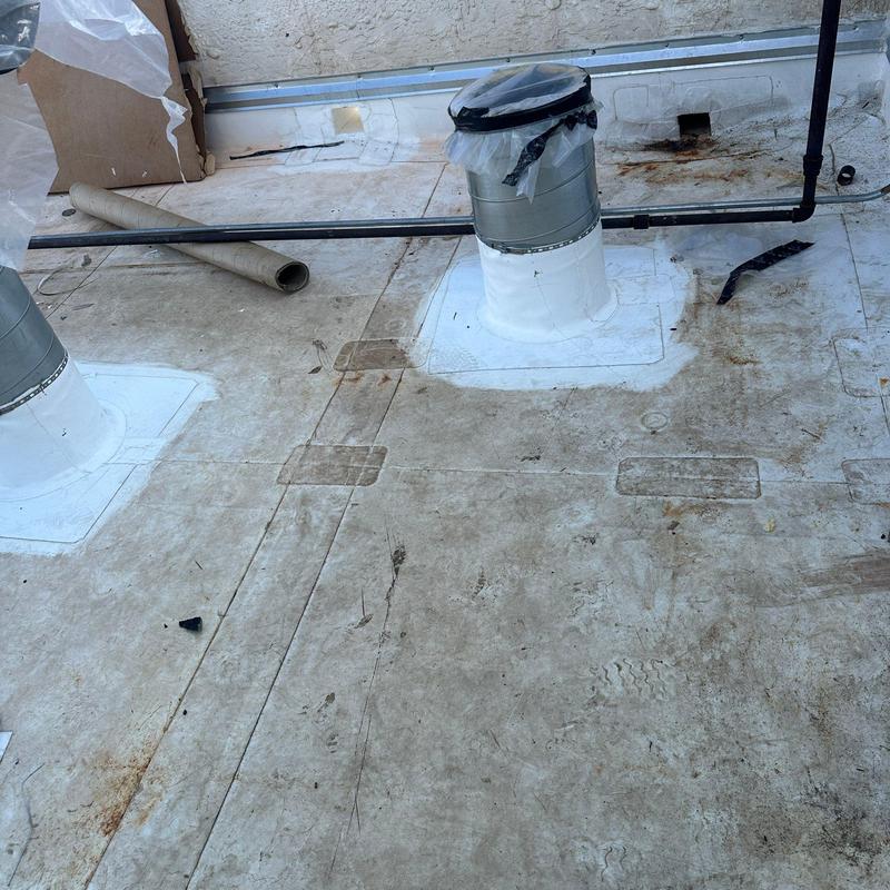 Concrete roof with patched roof vents and flashing Concrete roof with patched roof vents and flashing