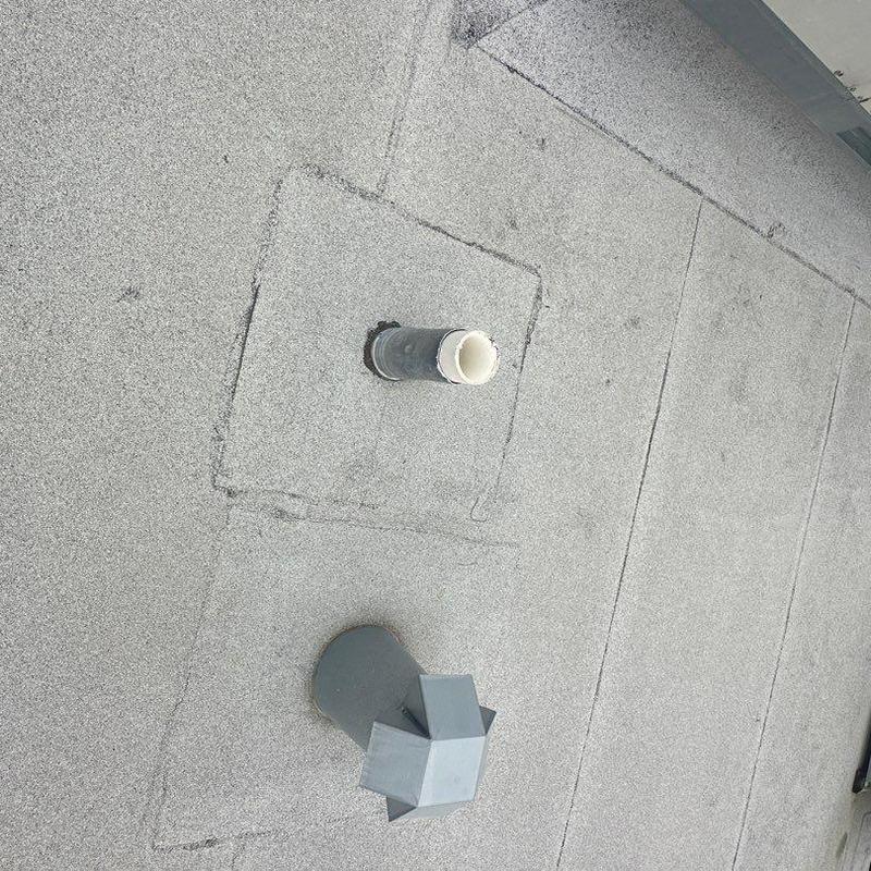 Concrete roof patch with vent pipe and flashing in gray Concrete roof patch with vent pipe and flashing in gray