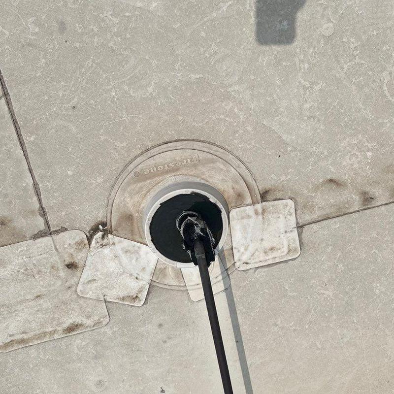 Roof membrane with sealed pipe penetration and patches Roof membrane with sealed pipe penetration and patches