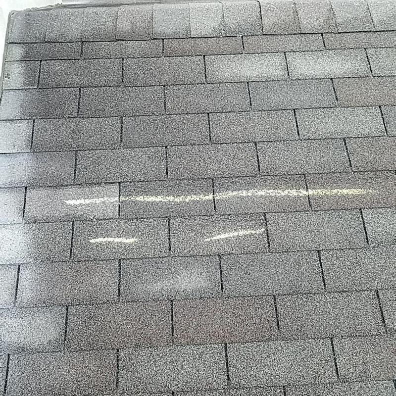 Architectural asphalt shingle roof with ridge cap in gray