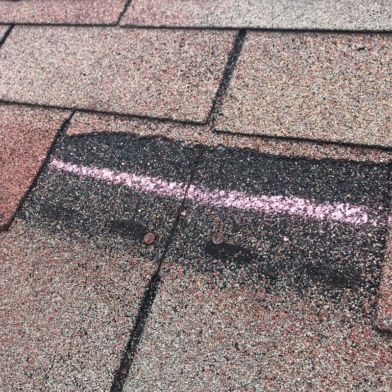 Architectural shingles with marked hail damage and nails