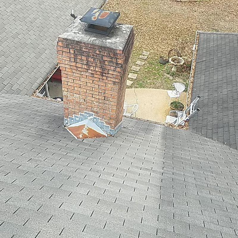 Shingle roof and chimney flashing on residential home