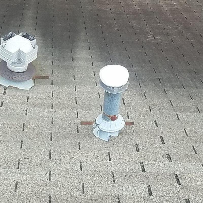 Asphalt shingle roof with metal vent pipes