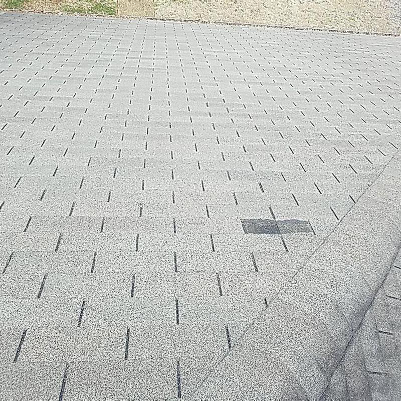 Architectural shingle roof with patched damaged shingles