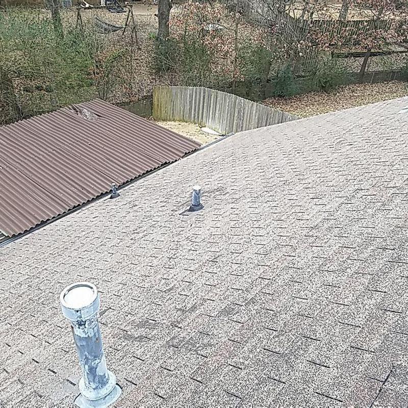 Architectural shingle roof with vent pipes and fence
