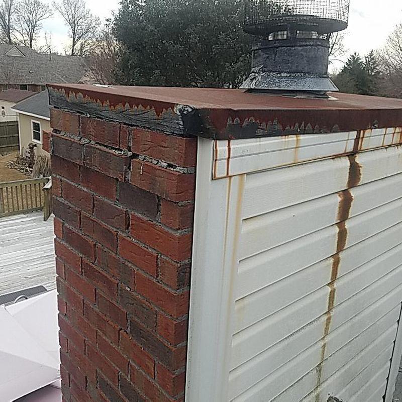 Chimney crown with rust and brick damage