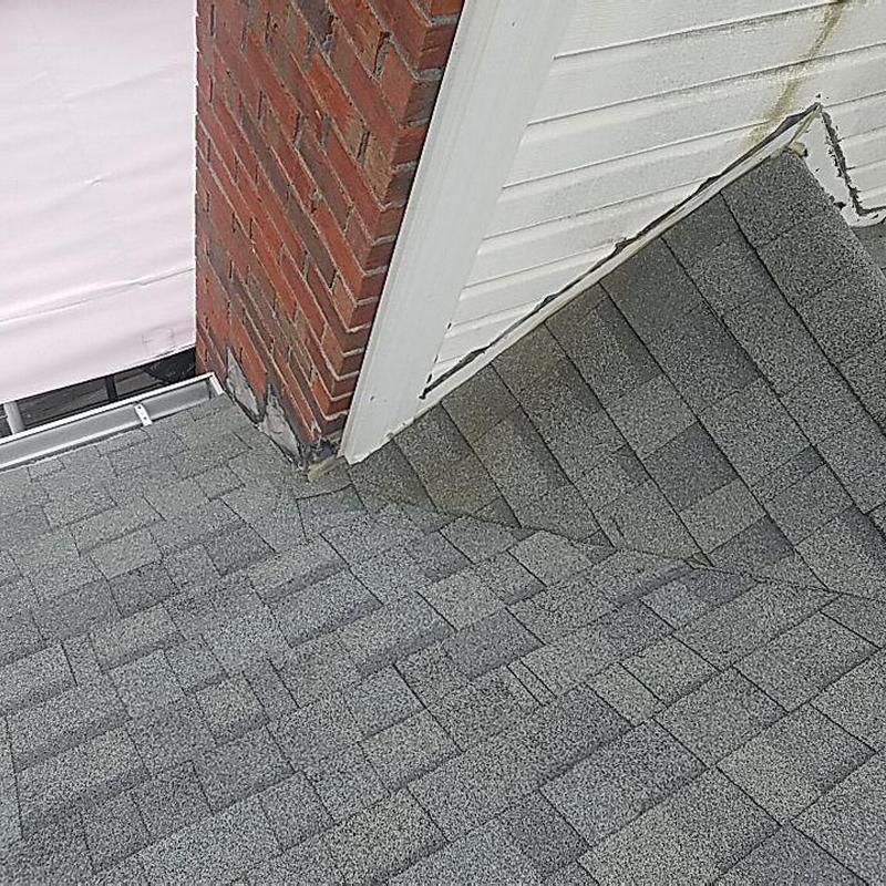 Chimney flashing and gray shingle roof detail