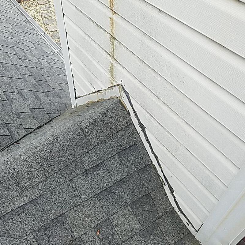 Chimney flashing and gray shingle roof details