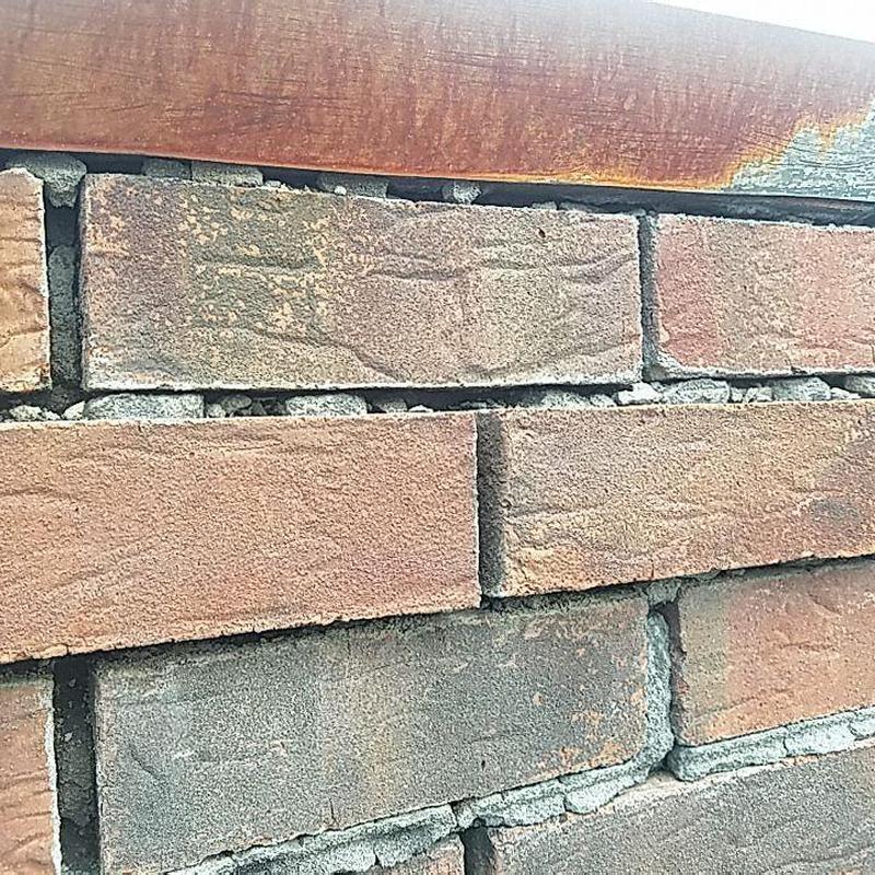 Brick chimney mortar and flashing gap close-up