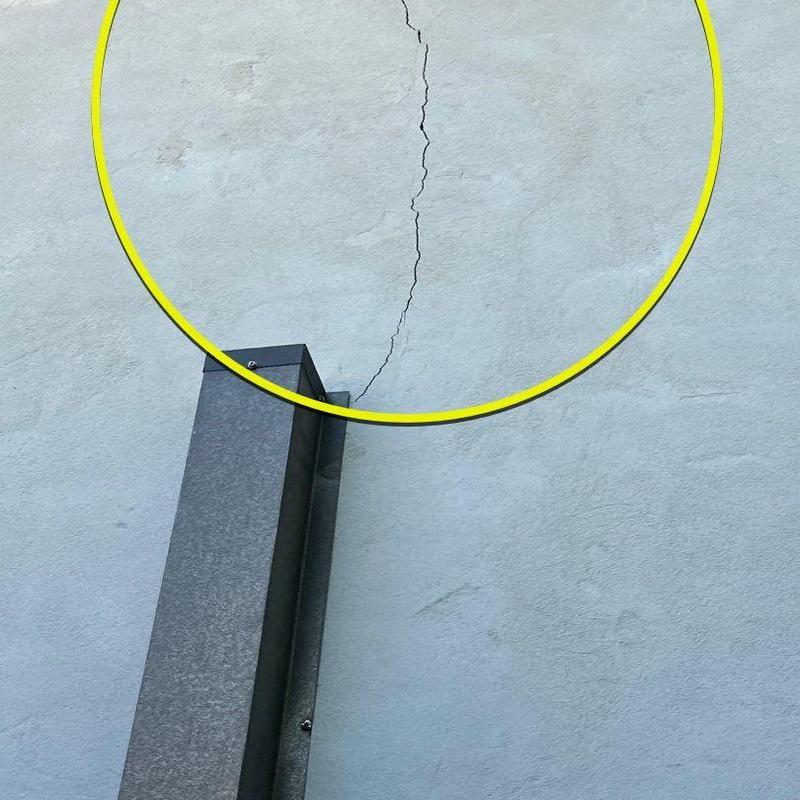 Stucco wall crack near exterior downspout Stucco wall crack near exterior downspout