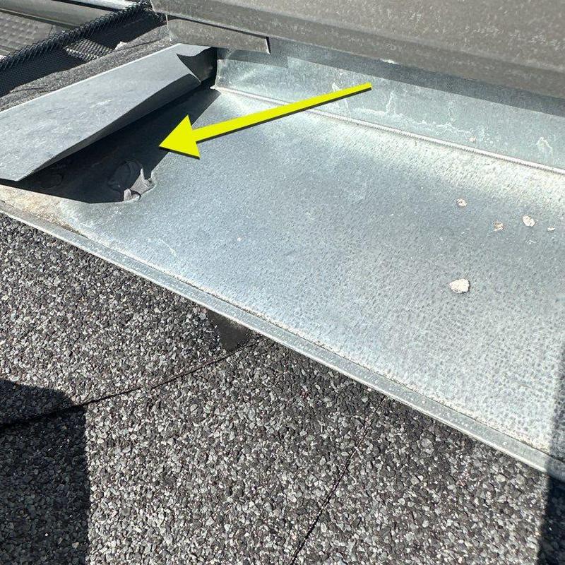 Roof flashing metal with dent near shingle roof Roof flashing metal with dent near shingle roof
