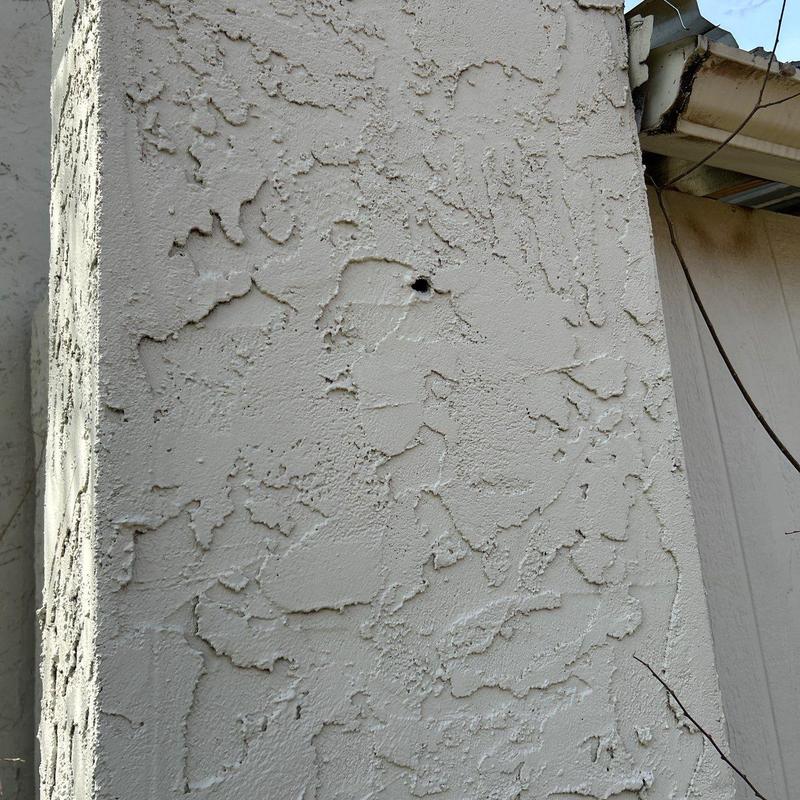 Stucco exterior wall with cracking and peeling texture Stucco exterior wall with cracking and peeling texture