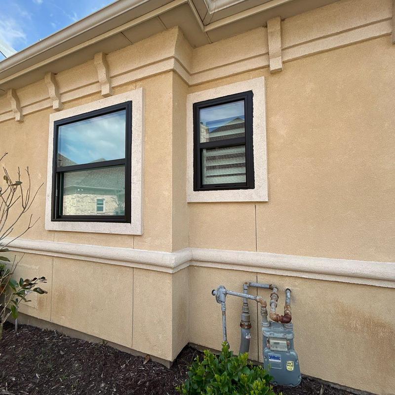 Exterior stucco wall with trimmed windows and gas meter Exterior stucco wall with trimmed windows and gas meter