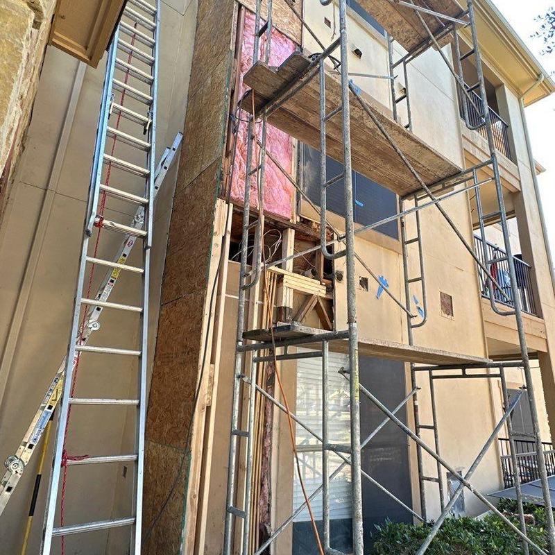 Exterior stucco wall with scaffolding and repair work Exterior stucco wall with scaffolding and repair work