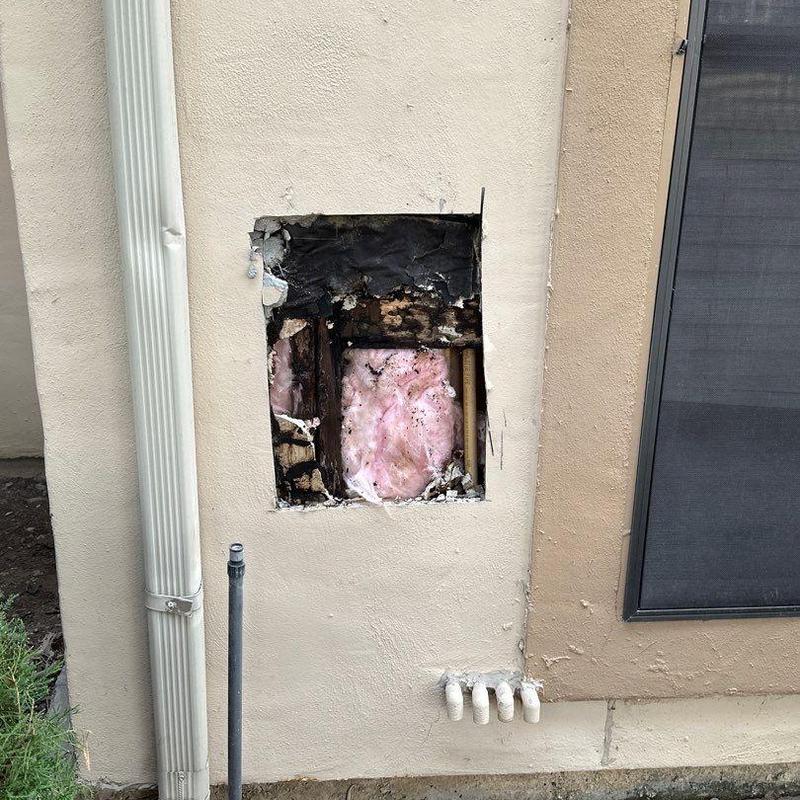 Stucco exterior wall with opened damaged section Stucco exterior wall with opened damaged section