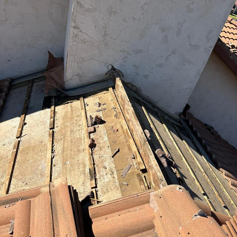 Chimney stucco and roof base with removed tiles Chimney stucco and roof base with removed tiles