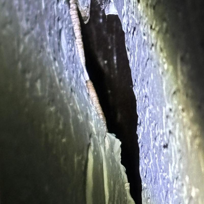 Cast iron pipe with severe corrosion leak in wall cavity Cast iron pipe with severe corrosion leak in wall cavity