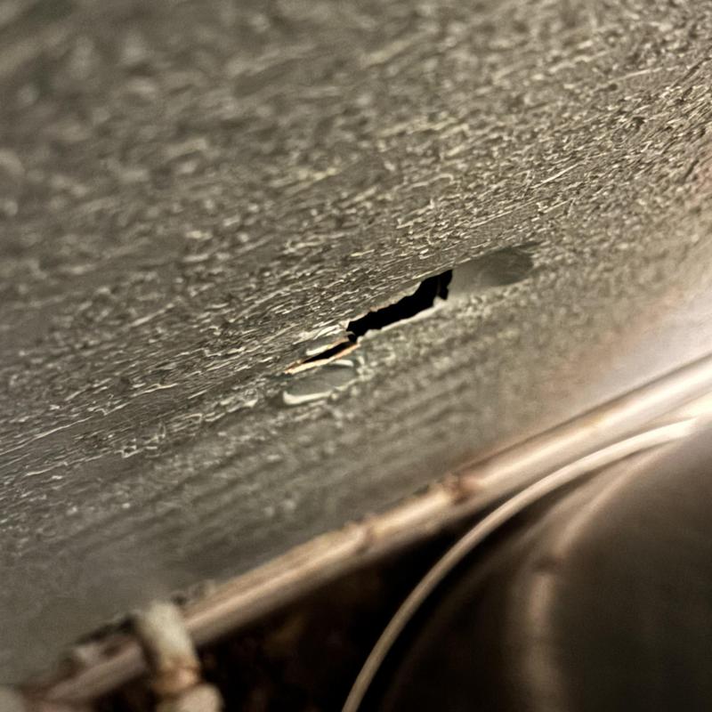 Water pipe behind damaged drywall near sink basin Water pipe behind damaged drywall near sink basin