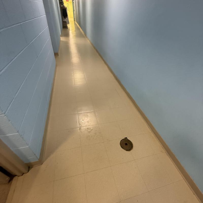 Commercial main line access cover in hallway floor Commercial main line access cover in hallway floor