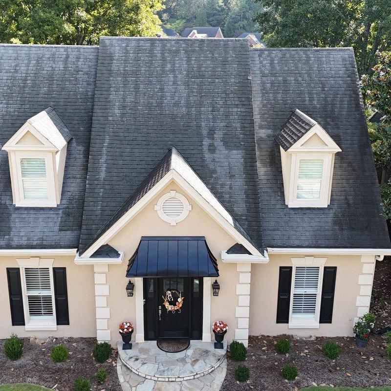 Asphalt shingle roof with discoloration and dormers Asphalt shingle roof with discoloration and dormers