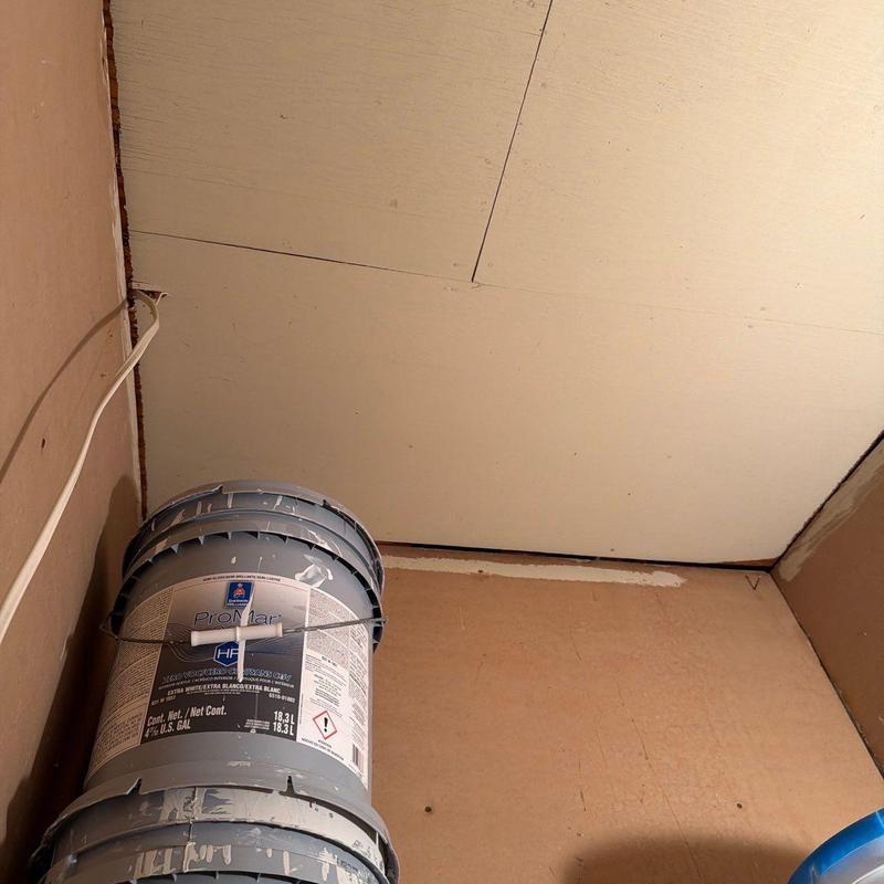 Ceiling drywall installation with paint buckets nearby